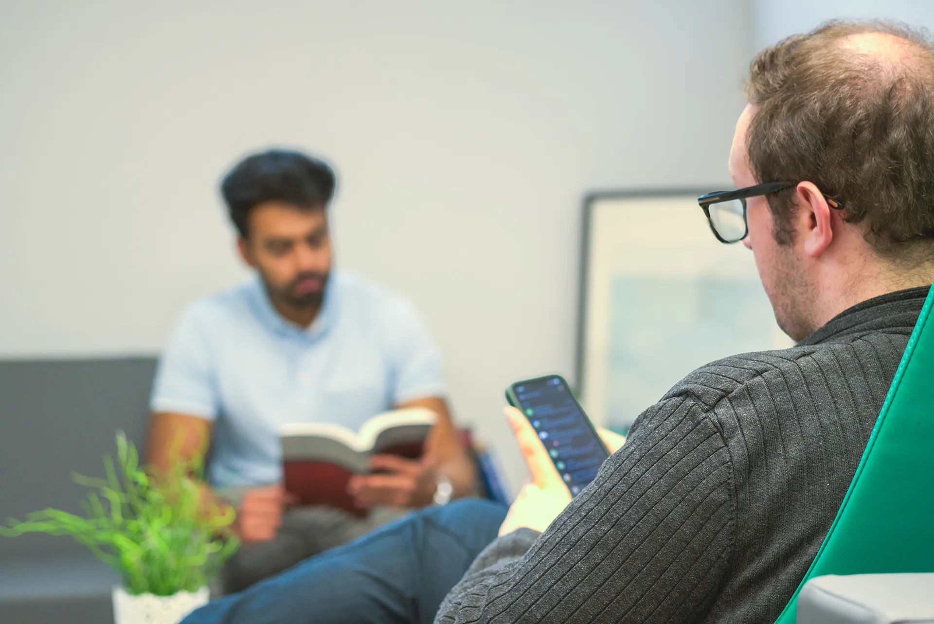 Graduate Students' Association GSA students reading and looking at a phone